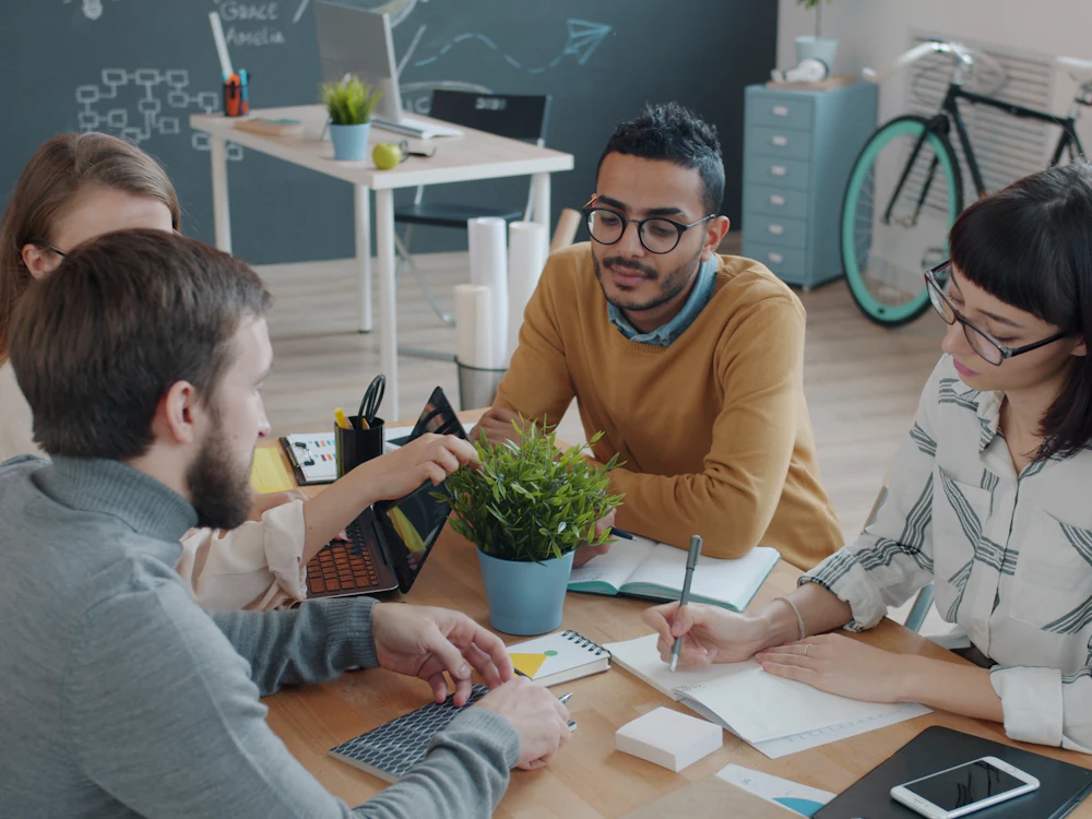 Diverse team of professionals collaborating together in a modern office